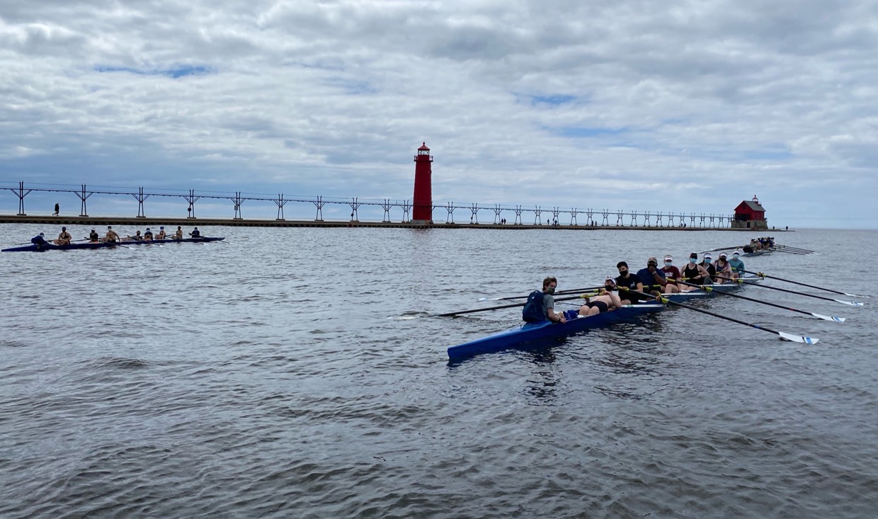 Rowing boats row to Lake Michigan in teams of 8.